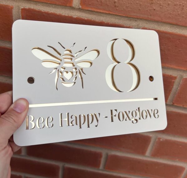 House number sign with Bee